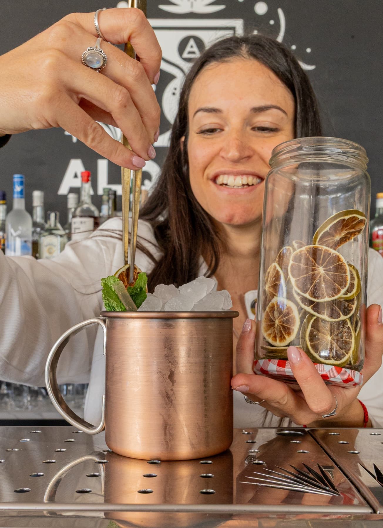 Alquimia Academy bartender preparing a garnish in the Cala de Bou laboratory.